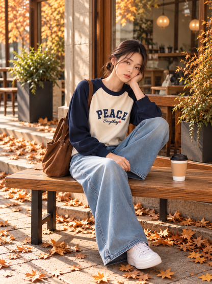PEACE navy raglan sweatshirt styled on a model