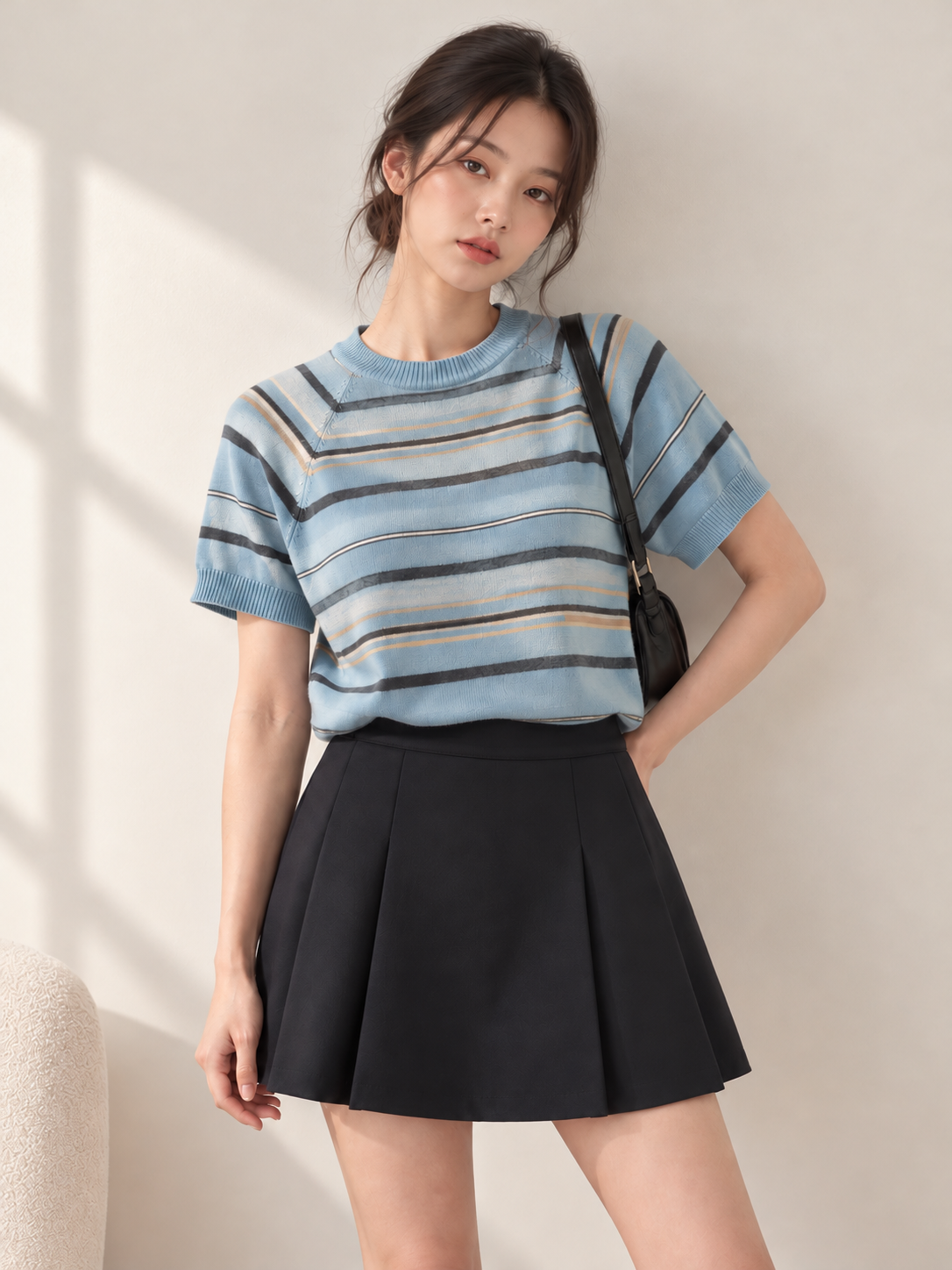 Blue striped short sleeve knit top styled on a model - closer 3:4 portrait