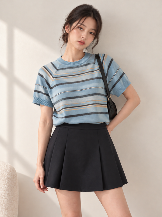 Blue striped short sleeve knit top styled on a model - closer 3:4 portrait